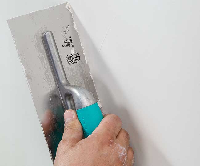 Frattone americano liscio in acciaio con manico in gomma 12 x 28 cm